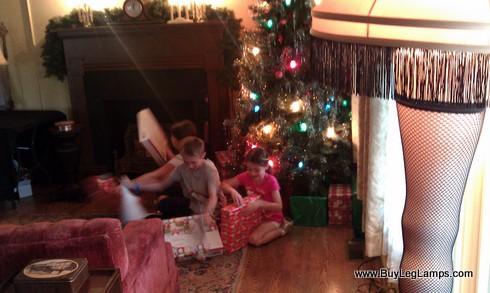 The kids opening gifts under the tree